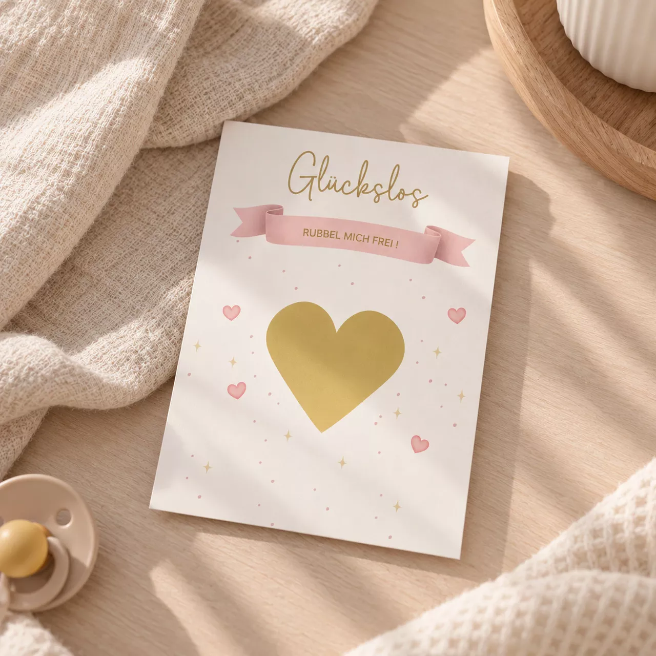 Rubellos zur Schwangerschaftsverkündung mit goldfarbenem Rubbelherz