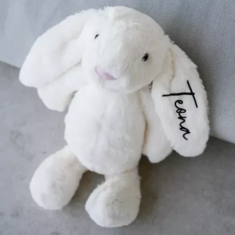 White plush bunny with printed name on the ear, cuddly soft toy as a personalised gift for birth or christening